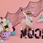 Adorable preschool dancer on a pastel Halloween background